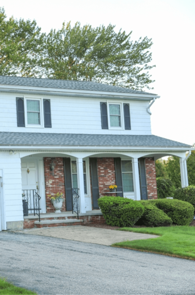 White Brick House With Black Shutters And Black Front Door